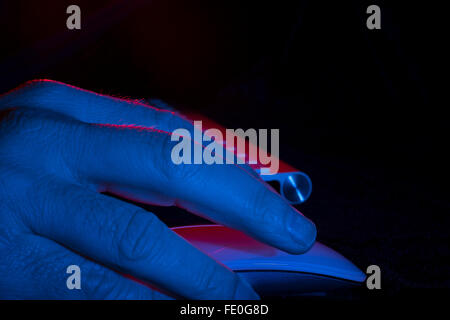 Man's hand hovering over Apple Magic Mouse Stock Photo