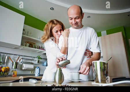man and woman preparing coffee in home Stock Photo
