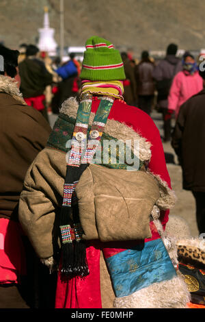 China, Tibet, Gansu province, Xiahé, Labrang monastery, Tibetan New Year's Day, woman wearing the traditional Amdo dress Stock Photo