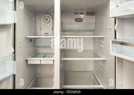 Open home refrigerator with empty shelves Stock Photo