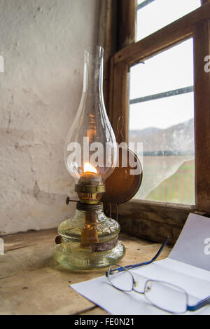 Vintage kerosene lamp at window Stock Photo