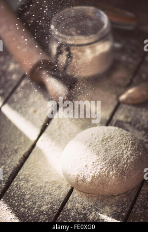 Freshly made dough on a farmhouse table. Stock Photo