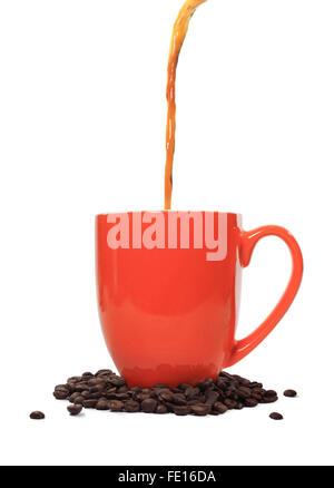 Studio Shot of Coffee being poured into an Orange Coffee Cup with Scattered Coffee Beans Stock Photo