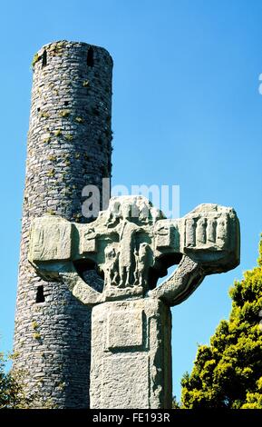 The Unfinished Cross and Round Tower in Celtic Christian churchyard at Kells in County Meath, Ireland Stock Photo