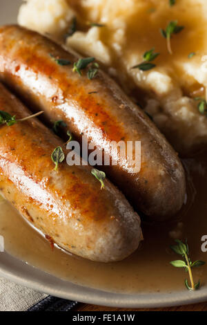 Homemade Bangers and Mash with Herbs and Gravy Stock Photo