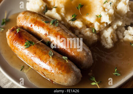 Homemade Bangers and Mash with Herbs and Gravy Stock Photo