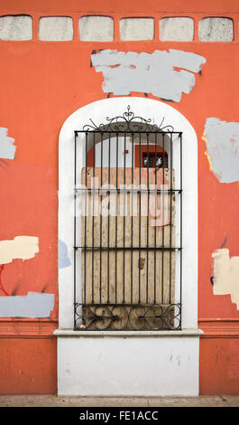 Boarded-up window in multicolored wall, Oaxaca City, Oaxaca, Mexico Stock Photo