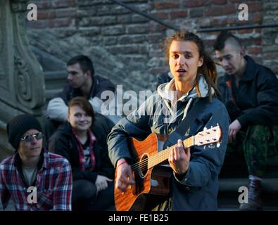 Gdansk Poland. Young street musician singing busking outside the Main Town Hall on the Dlugi Targ Long Market Stock Photo