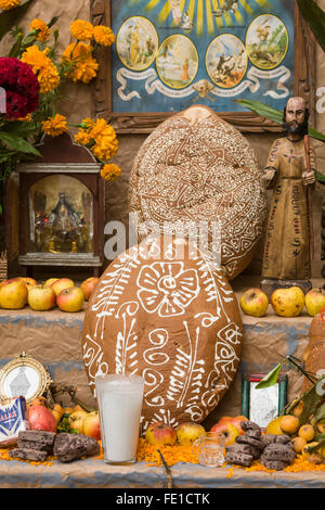 Traditional Pan de Muerto sweet bread, fruits, chocolate and flower offerings on an altar decorated for the Day of the Dead, Oaxaca, Mexico Stock Photo