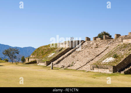 Tourists couple visiting ruins of a stone pyramid at Monte Alban, a World Heritage archaeological site, Oaxaca, Mexico. Famous destinations landmarks. Stock Photo