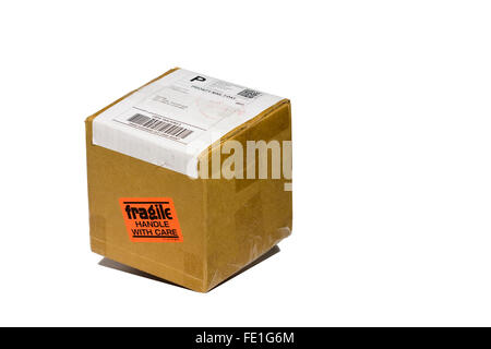 Cut Out. Falling Cardboard Box. Fragile Handle With Care Sticker on box being sent by US Postal Service Priority 2 Day Mail Stock Photo