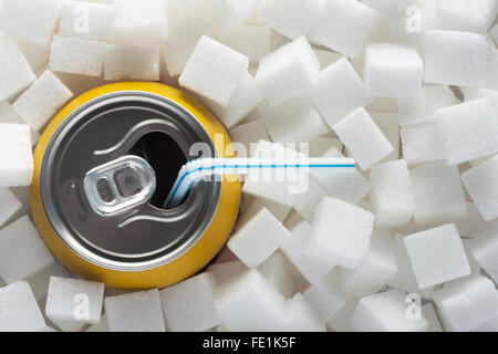 Unhealthy food concept - sugar in carbonated drink. Sugar cubes as background and canned drink Stock Photo