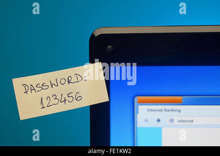 Too easy password on sticky notes on laptop screen. Focus on password Stock Photo