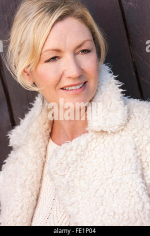 Portrait of attractive smiling middle aged woman with perfect teeth Stock Photo