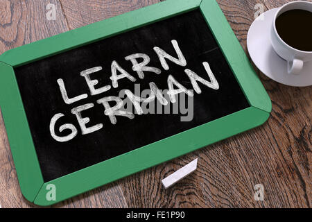 Hand Drawn Learn German Concept on Chalkboard. Stock Photo