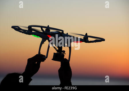 ITALY-OCT.30: DJI Phantom quadcopter is on the record with GoPro Hero3 HD camera with a beautiful sunset in the background the clouds on the 30th of october in italy. Quadcopter industry is told to be growing at triple digitsevery year, for a market expected to pass the 20 billion in the 2020. The dji is a chinese company leader of quadcopter industry, and the phantom is expected to be the top seller gift for christmas 2015 Stock Photo