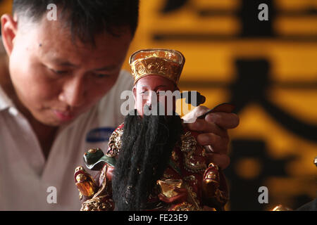 Sumatra, Indonesia. 04th Feb, 2016. Indonesian of Chinese descent wash Chinese god statue in preparation for Chinese New Year celebration at a temple Gunung Timur, North Sumatra, Indonesia, February 4, 2016. A ritual was held in the Chinese lunar calendar in month 12, as is believed the gods back to meet in heaven in celebrating the Chinese New year, the Chinese community in the country's most populous Muslim in the world are getting ready to celebrate the beginning year of the monkey, which falls on February 8, 2016. Credit:  Ivan Damanik/Alamy Live News Stock Photo