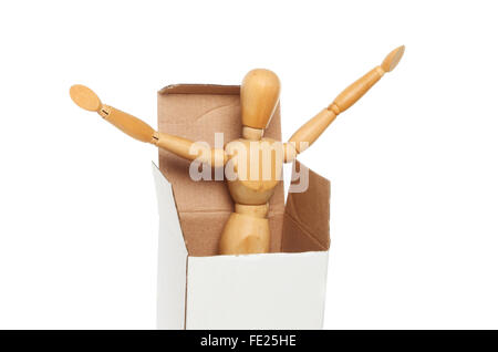 An artist's wooden manikin springs out of a cardboard box isolated against white Stock Photo
