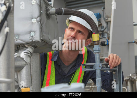 Industrial engineer examining high temperature sensor connections at a power plant Stock Photo