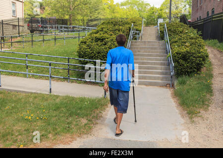 Man with Traumatic Brain Injury walking in his neighborhood Stock Photo
