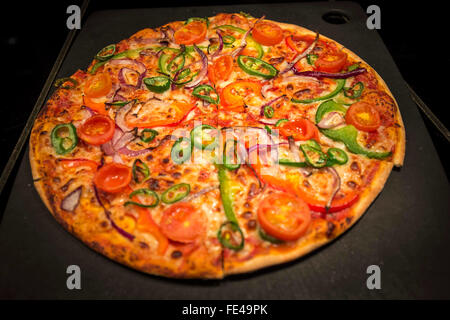 a thin crispy pizza in a Pizza Hut restaurant Stock Photo