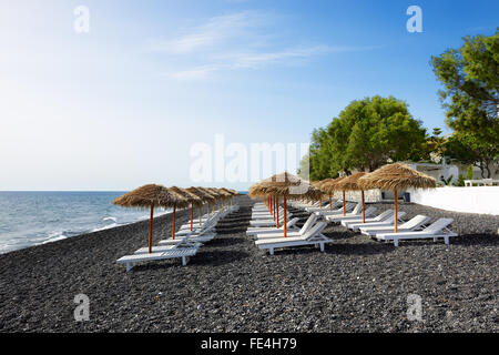 The beach with black volcanic stones at Santorini island, Greece Stock Photo