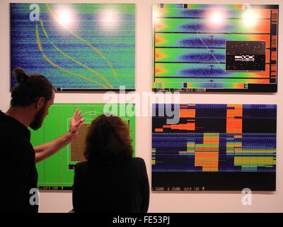 New York, NY, USA. 03rd Feb, 2016. Visitors look at images at the opening of the exhibition 'Astro Noise' from US American artist Laura Poitras in the Whitney Museum of American Art in New York, NY, USA, 03 February 2016. Photo: Johannes Schmitt-Tegge/dpa/Alamy Live News Stock Photo