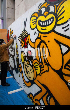 Street artist painting cartoon animals. Chinese New Year, Manchester, UK. 4th Feb 2016  Tag Graffiti Artist known as Forty Five, 45, from Bristol is finishing his mural, for the Chinese Centre of Contemporary Art. The organisation is celebrating its 30 year anniversary in the city with the launch to coincide with the Chinese New Year. Stock Photo