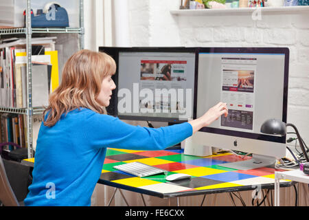 Woman checks her Internet bank account on a computer. Stock Photo