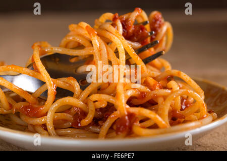 Spaghetti with tomato sauce and fork close up Stock Photo