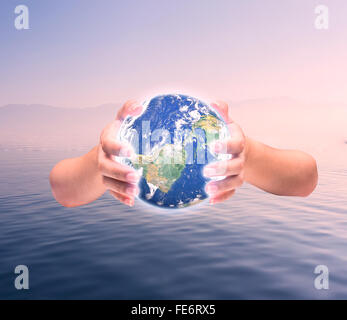 Human hand holding Earth planet. Elements of this image are furnished by NASA Stock Photo