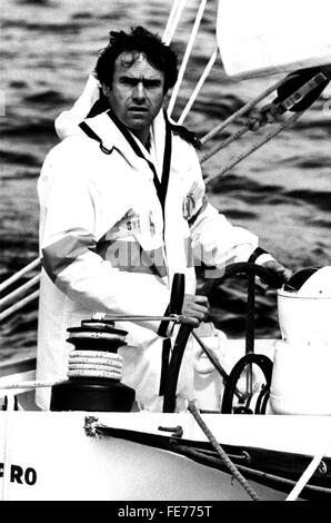 AJAXNETPHOTO. 2ND JUNE,1984. PLYMOUTH, ENGLAND. - SAILING - HISTORY - START OF OBSERVER-EUROPE 1 STAR 1984 - WINNER - FRENCH YACHTSMAN YVON FAUCONNIER AT THE WHEEL OF HIS YACHT UMUPRO JARDIN V. PHOTO:JONATHAN EASTLAND/AJAX  REF:1984 01 Stock Photo