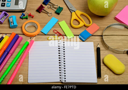 Blank notebook with school accessories on wooden table Stock Photo