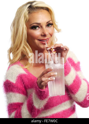 A young attractive blond woman is sipping ice water through a straw. Stock Photo