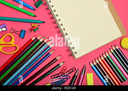 Blank notebook with school supplies on pink background Stock Photo