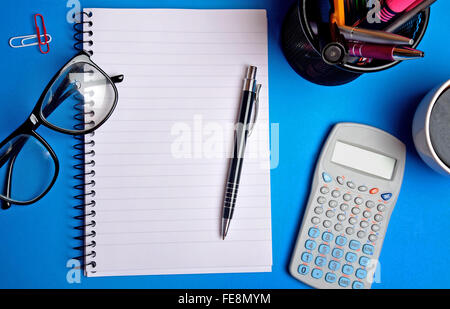 Notepad with office supplies on background Stock Photo