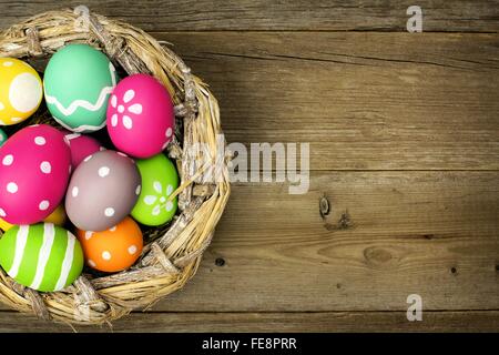 Easter eggs in a nest over an old wood background Stock Photo