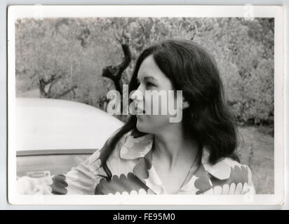1970s Outdoor portrait of a young woman in black and white taken with 35mm film Stock Photo