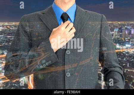 Double exposure of young businessman and beautiful night city background. Stock Photo