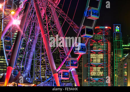The observation wheel, and HSBC building lighting in Chinese 'Prosperous New Year', Hong Kong, China. Stock Photo