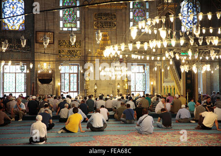 People praying in Yeni Cami Mosque, Istanbul, Turkey Stock Photo