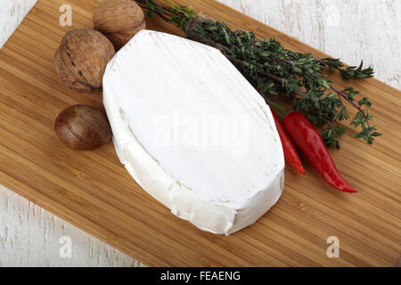 Brie cheese with thyme leaves and nuts Stock Photo