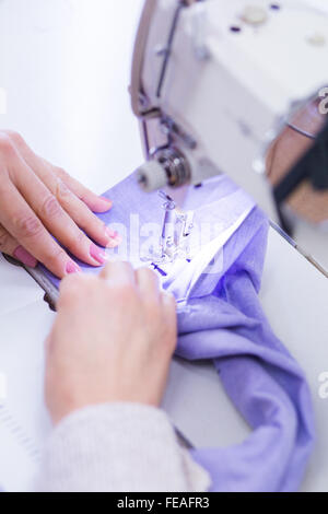 Woman using a sewing machine in the workshop Stock Photo