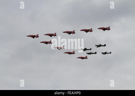The RAF Red Arrows Display Team in formation with the Battle of Britain Memorial Flight fighters Spitfire Hurricane Stock Photo