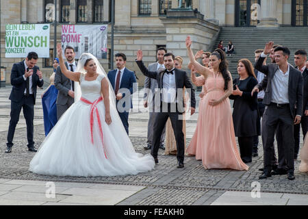 A wedding party celebrate in Gendarmenmarkt, Berlin, outside the Berlin Concert House. Stock Photo