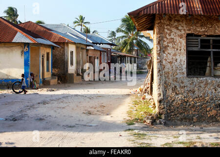 Young boy playing in front of their houses in Jambiani village (Zanzibar). Stock Photo