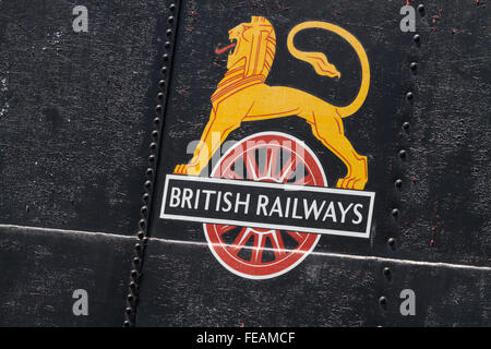 Weathered British Rail cycling lion logo on the tank side of an out of service locomotive at Peak Rail, rust, rivets and worn pa Stock Photo