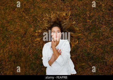 Portrait of a beautiful girl lying in a pine forest Stock Photo