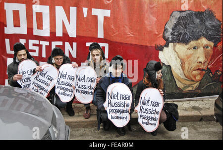 Kiev, Ukraine. 5th Feb, 2016. Ukrainian activists holds in hands symbolic ears with inscriptions ''Do not listen to Russian propaganda!'' in different languages, in front of a banner featureing Vincent Van Gogh's self-portrait with the cut off ear, during their performance near the Netherlands Embassy, in Kiev, Ukraine, on 05 February, 2016.The activists called upon Netherlands to not trust Russian propaganda against Ukraine ahead of a referendum on an association agreement of the Ukraine with EU, which will take place in the Netherlands on 06 April 2016. © ZUMA Press, Inc./Alamy Live News Stock Photo