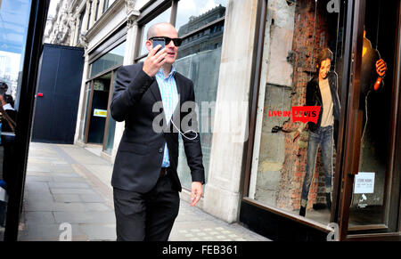 London, England, UK. Man walking and talking on a mobile phone Stock Photo